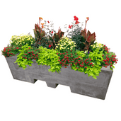 Antraciet betonnen afzetblok/bloembak met lepelgaten, gevuld met diverse bloemen en planten.
