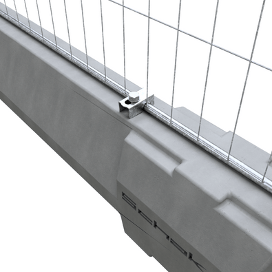 Grijze betonnen dwarsligger met een metalen bouwhekklem die een gaashekwerk bevestigt.