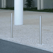 Twee RVS parkeerpalen Ø60 mm, zilverkleurig en strak vormgegeven, verankerd in een lichtgrijze ondergrond.